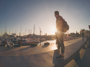 young tourist man staring to the sunset at Barcelona port young tourist man staring to the sunset at Barcelona port